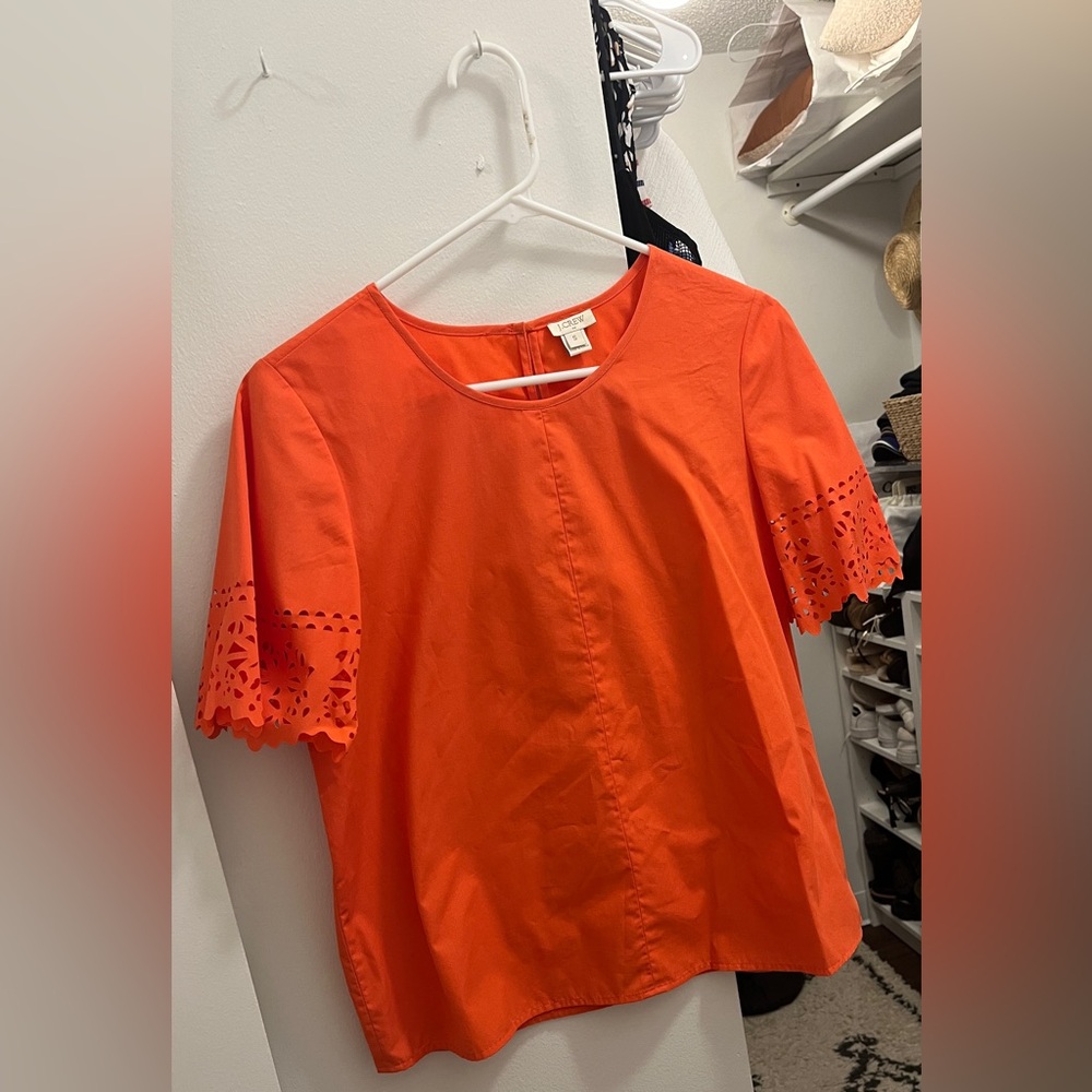 JCrew orange top with cutout detail on sleeve
